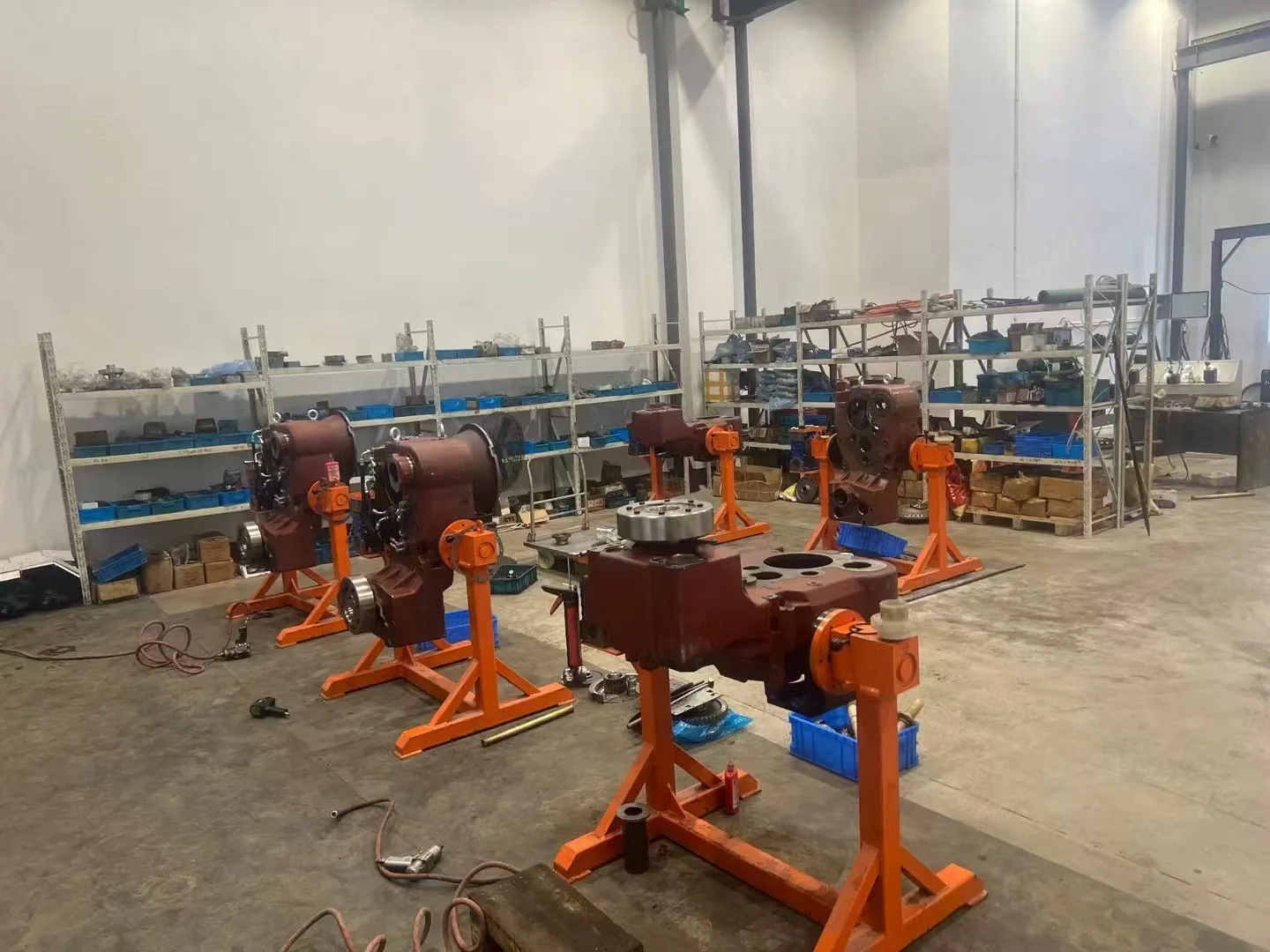 Machinery component workshop with assembly stands and storage shelves