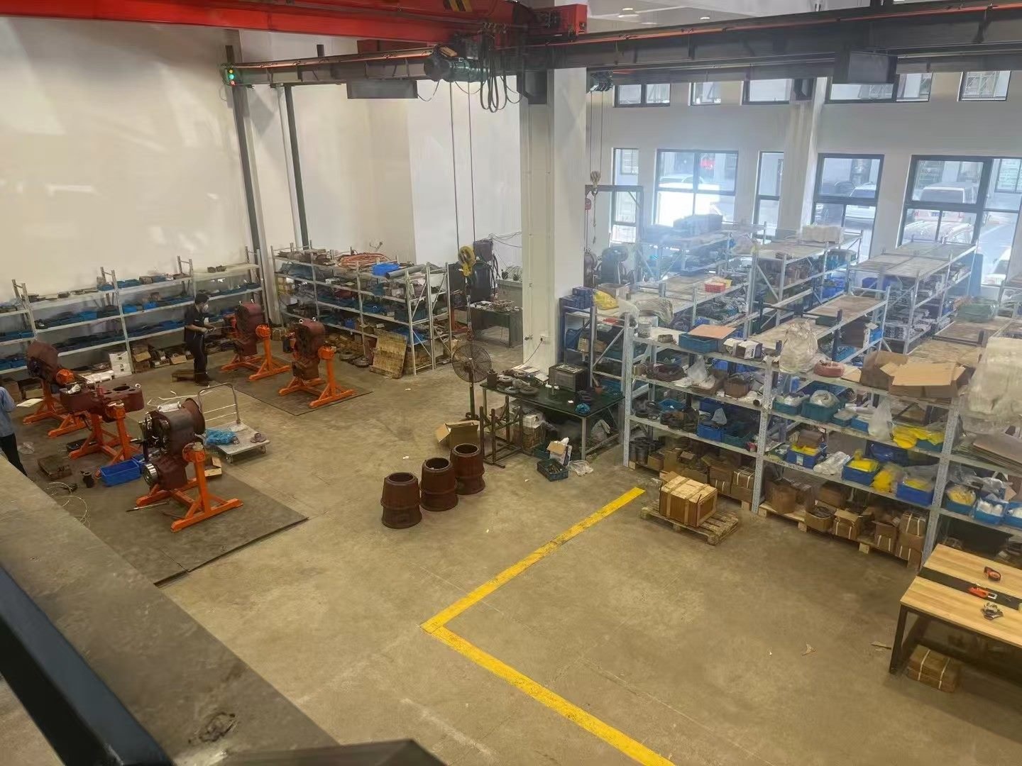 Machinery workshop with component shelves and assembly stands