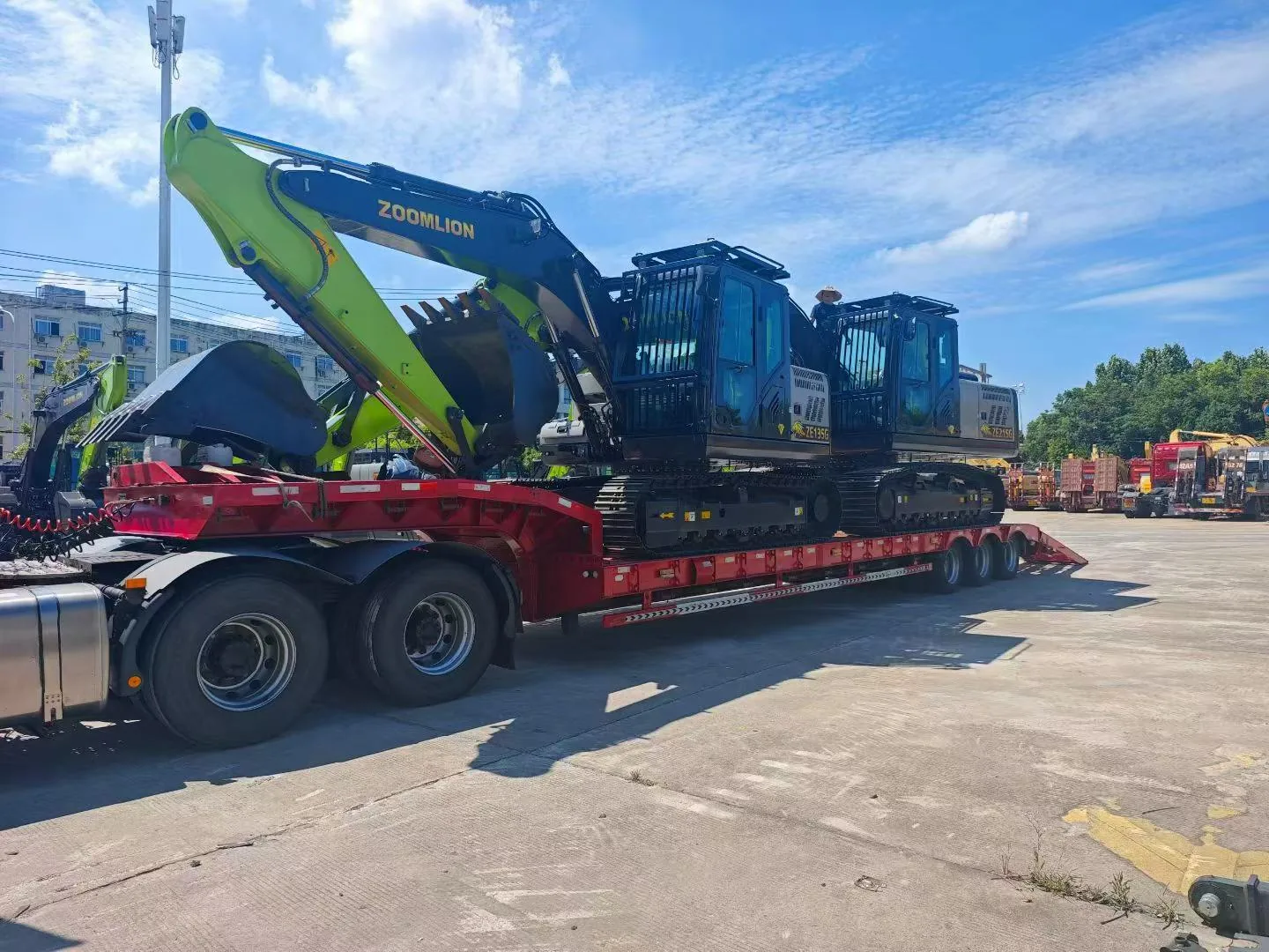 Tracked excavators positioned on low-bed trailers