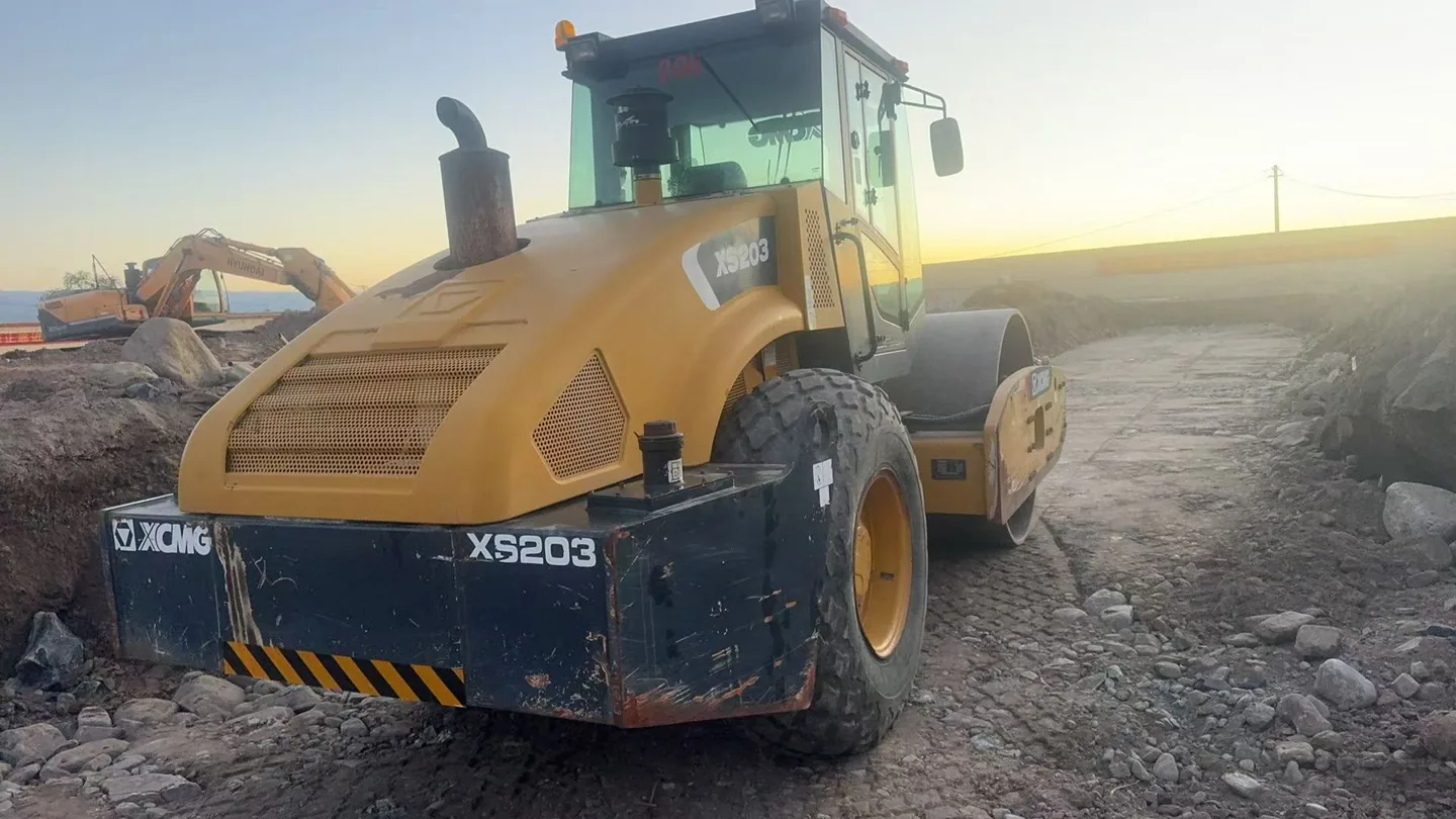 Single-drum road roller photographed in an equipment yard